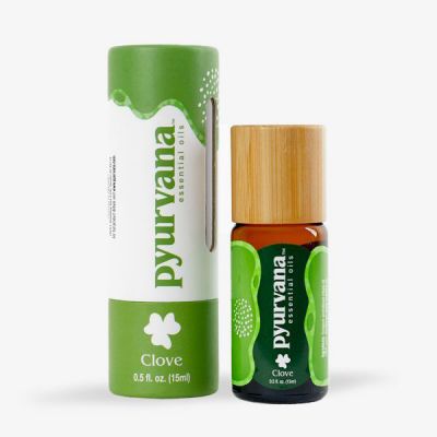 bottle of a clove oil by Pyurvana next to a cardboard tube