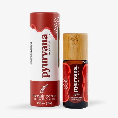 a bottle of Pyurvana's best boswelia serrata frankincense oil next to a small cardboard tube