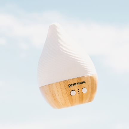 two essential oil diffusers on a light blue background