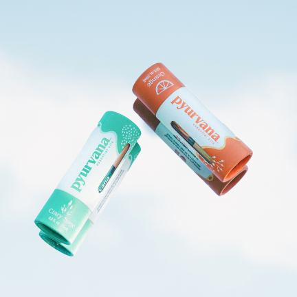 an individual bottle of lavender essential oil on a purple background