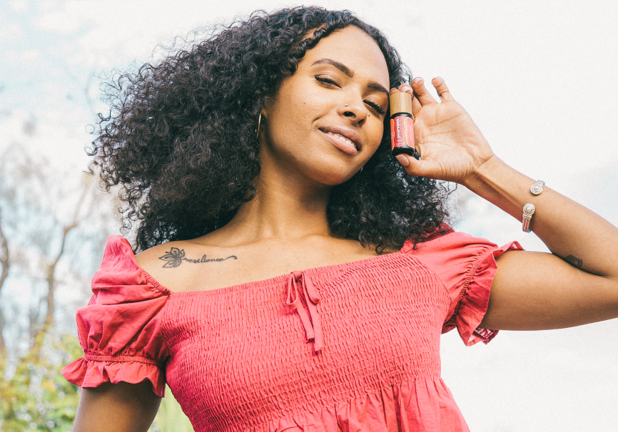 Model holding grapefruit essential oil