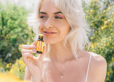 women smelling bottle of essential oil