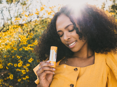 Model holding ylang ylang essential oil