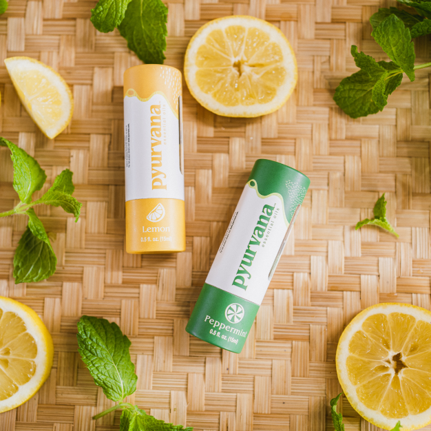 two unlabeled essential oil bottles on a yellow background with a pyur scents logo for Pyurvana's blogs